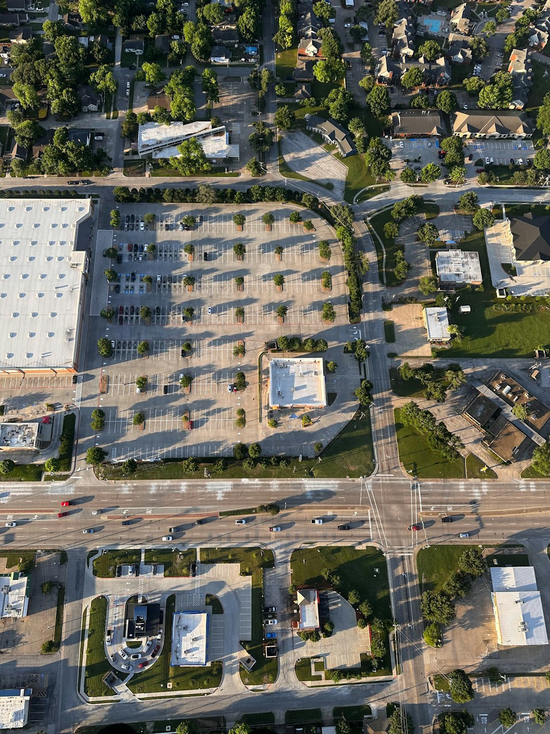 aerial-view-of-a-suburban-street-with-businesses-and-homes-km-ledjzbe4